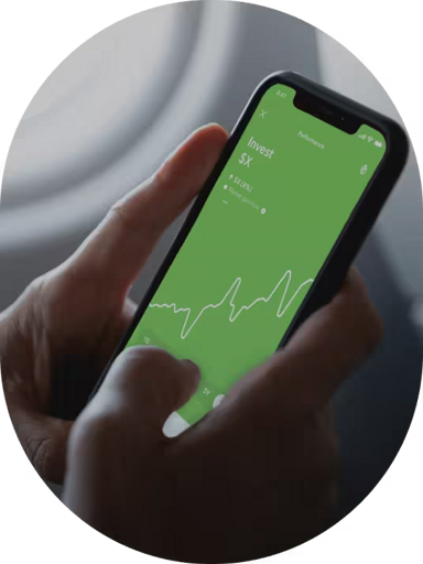 Hands holding phone with Acorns app