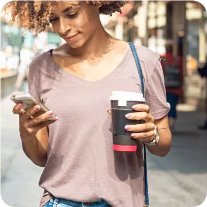 Woman holding phone and coffee